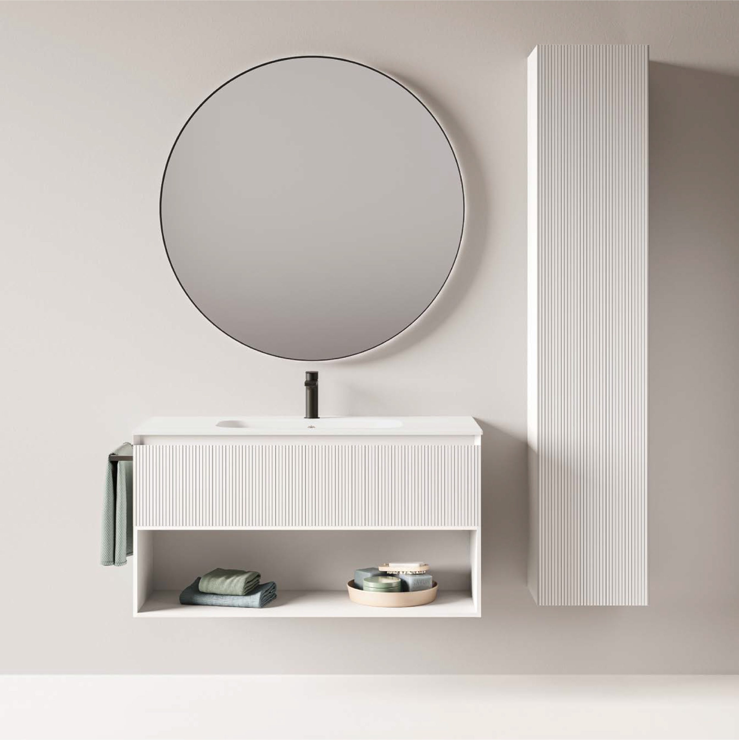 Bathroom setup with a round mirror, sink, and tall cabinet against a light gray wall.